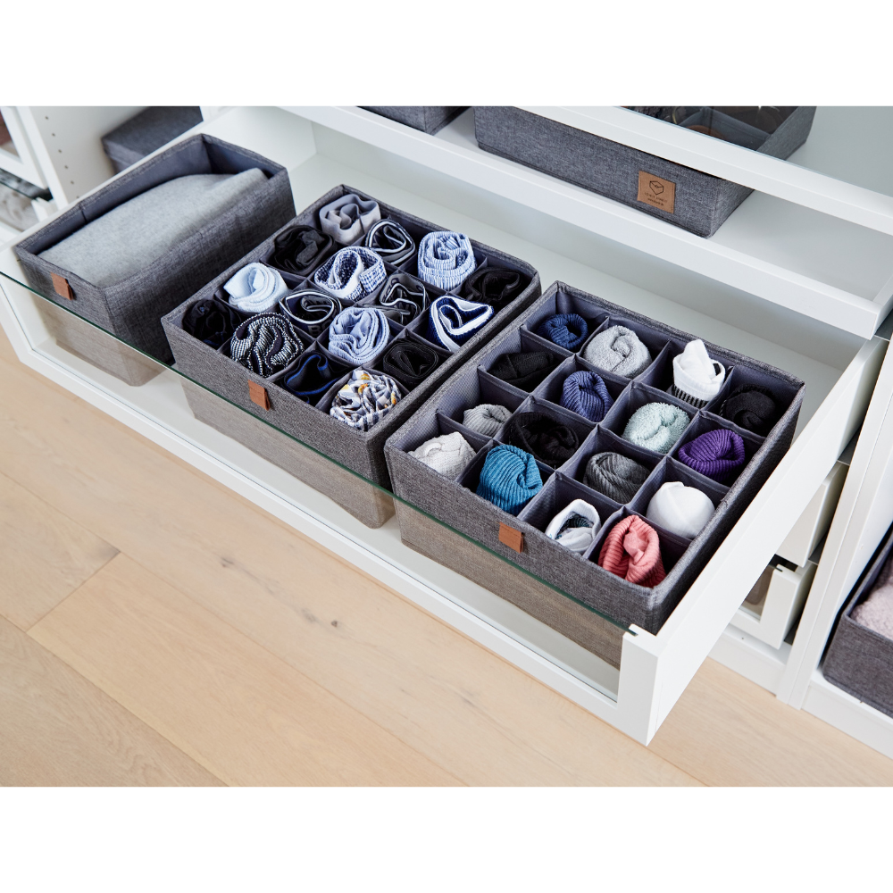 De PREMIUM Organizer met 16 vakken in grijs – set van 2 stuks van Love it Store it, gemaakt van linnen, zorgt ervoor dat sokken en ondergoed overzichtelijk in een witte lade worden opgeborgen; extra opbergmanden staan op de plank erboven.
