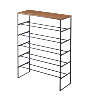 De TOWER schoenenrek van hout - zwart van YAMAZAKI biedt ruimtebesparende schoenenopslag op 6 open niveaus, met een zwart metalen frame en een houten plank.